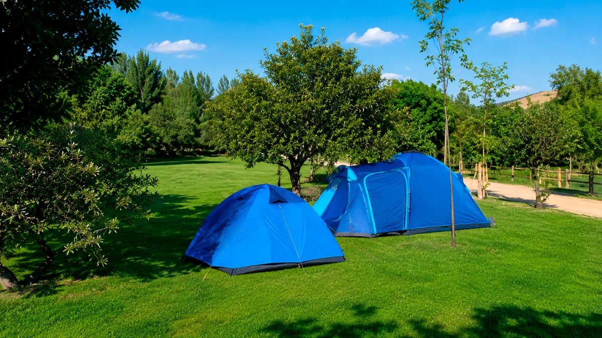 Tienda de campaña azul en camping de Guadarrama, normativa y vivac permitido