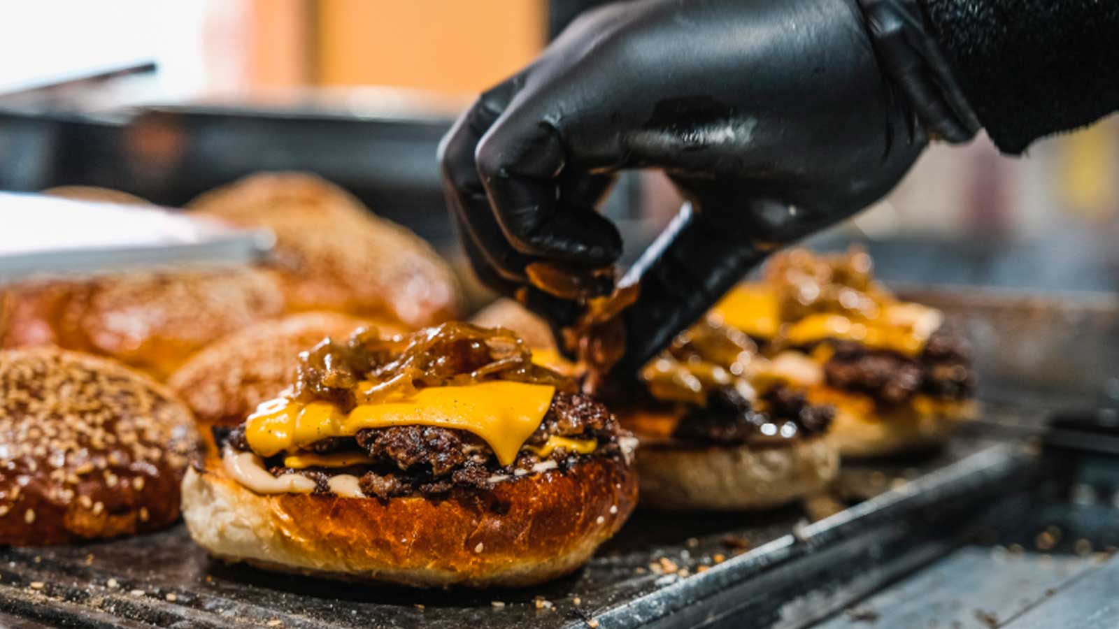 Preparación de una smash burger con queso en una hamburguesería